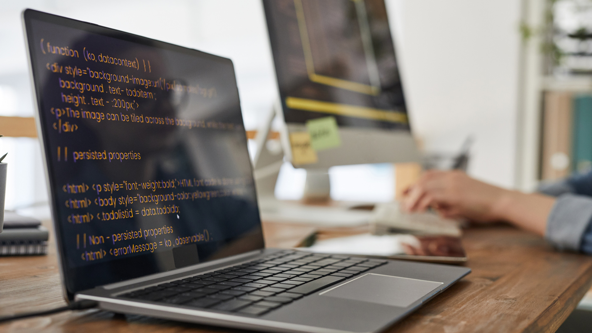 Two screens of code in a quiet room, something being built