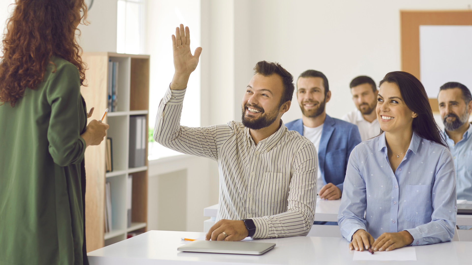 Somebody raising a hand to ask a question at a training session