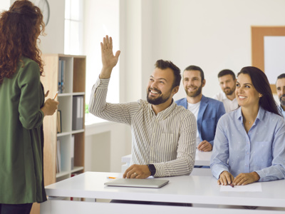 Somebody raising a hand to ask a question at a training session