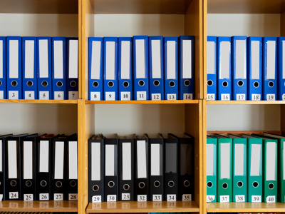 A shelf of ring binders, an organisation written down