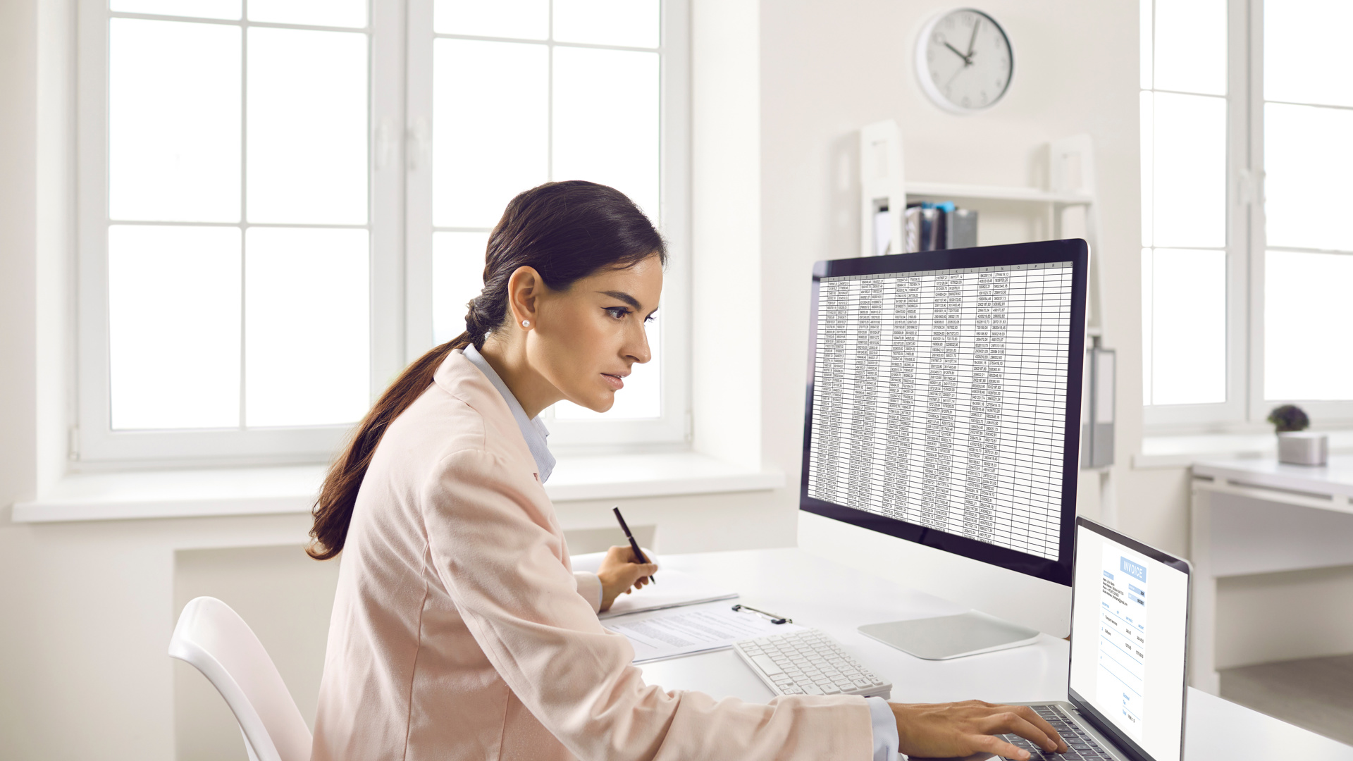 A membership officer working through a spreadsheet at her desk
