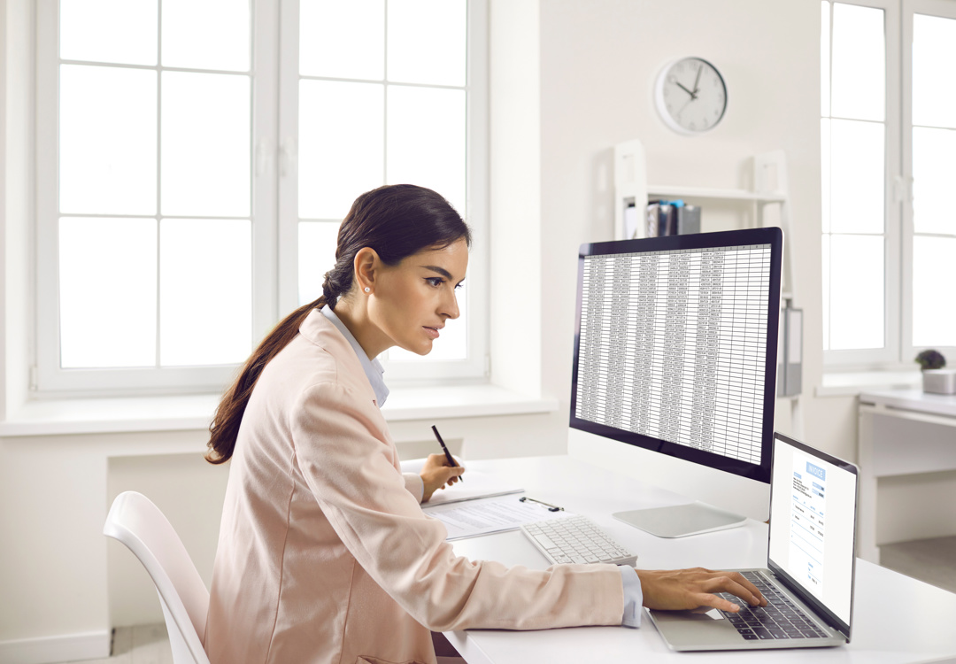 A membership officer working through a spreadsheet at her desk